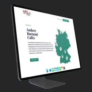 Ein seitlich-stehender flacher schwarzer Bildschirm auf dem man den Startbildschirm sieht von der Webseite www.anderes-burnout-cafe.de. Dieses Bild findet man auf der Webseite vom Bundesverband Burnout und Depression.